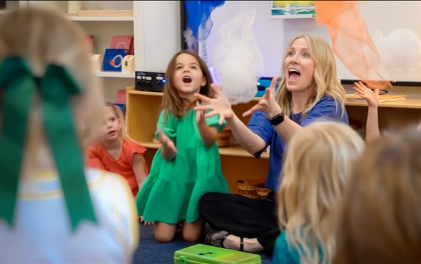 San Tan Montessori preschool students and their teacher enjoying an interactive group lesson