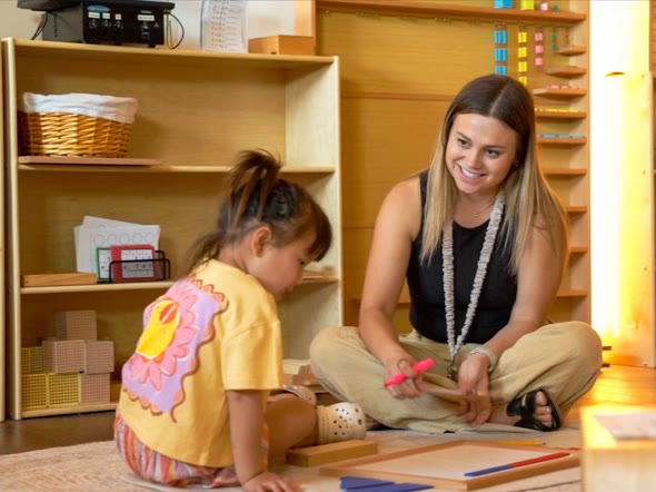 A San Tan Montessori preschool teacher supporting a child during individual work