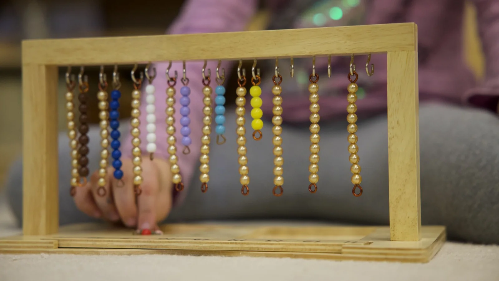 Hands-on Montessori bead work available in the prepared preschool environment